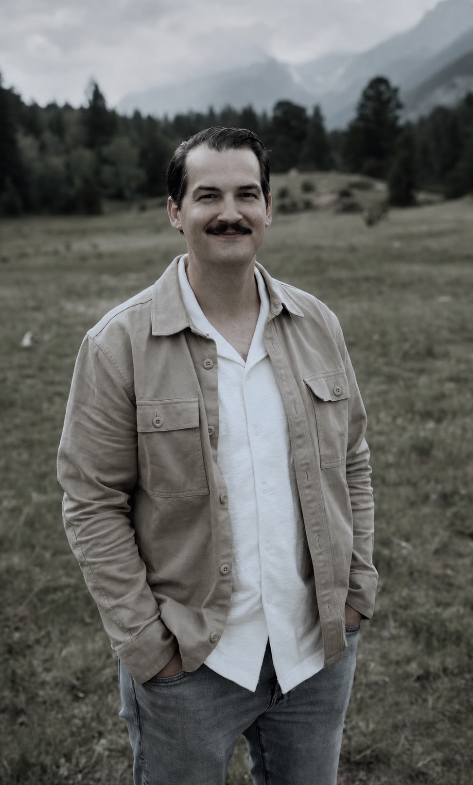 Eric Belvin standing in a mountain meadow